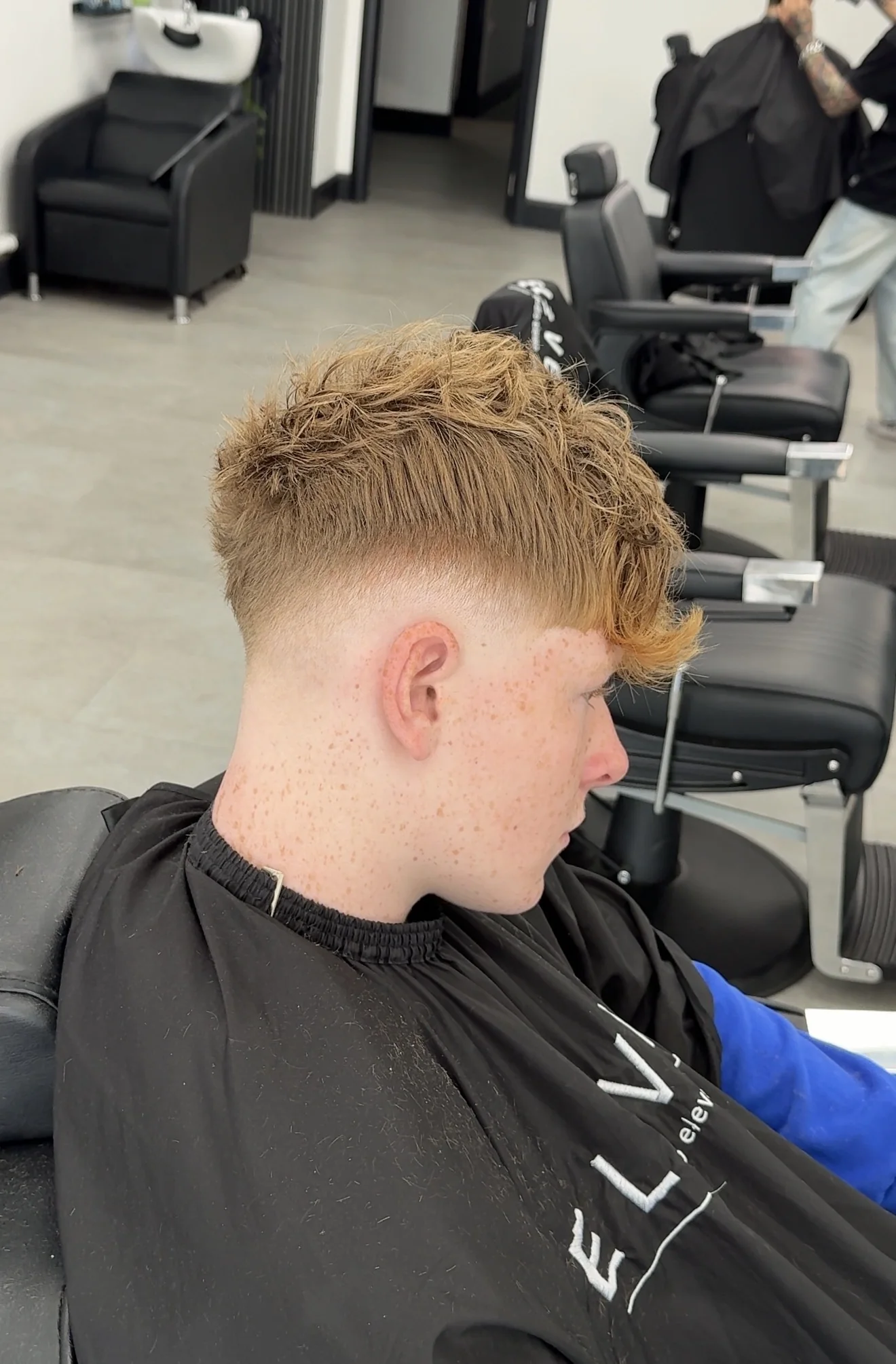 Studio Eleven barbershop haircut — textured crop and skin fade